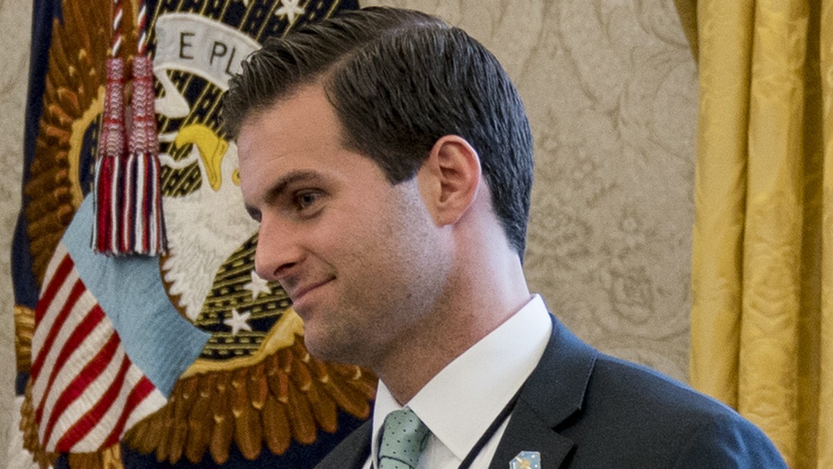 FILE - In this Jan. 31, 2018 file photo, White House aide John McEntee, right, and Treasury Secretary Steve Mnuchin's Chief of Staff Eli Miller, left, stand in the Oval Office as President Donald ...