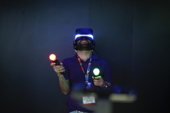 FILE - In this Tuesday, June 10, 2014 file photo, Jordan Saleh tries Sony&#039;s Project Morpheus virtual reality headset at the Electronic Entertainment Expo, in Los Angeles. Project Morpheus, Sony&# ...