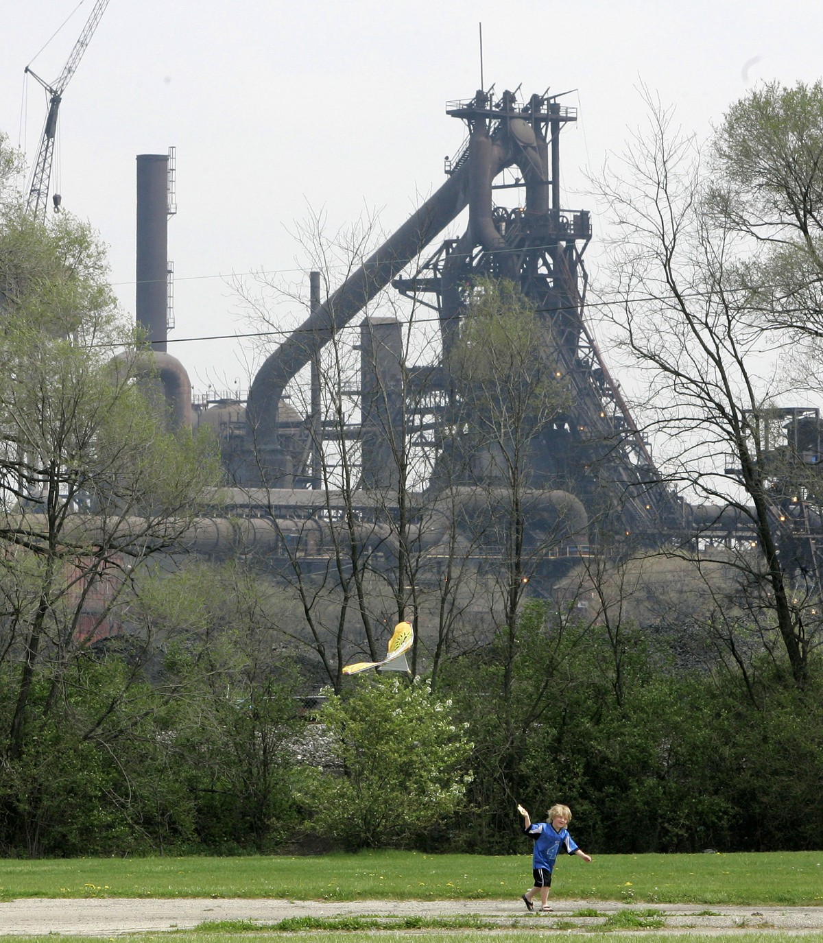 FILE – In this April 23, 2007, file photo, a child flies a kite near AK Steel's Middletown Works plant in Middletown, Ohio. Author J.D. Vance's book "Hillbilly Elegy: A Memoir of a Fami ...