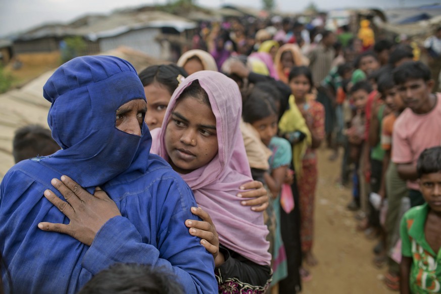 Rohingya Muslims, who crossed over from Myanmar into Bangladesh, wait in queues to receive aid at Kutupalong refugee camp in Ukhiya, Bangladesh, Wednesday, Nov. 15, 2017. Secretary of State Rex Tiller ...