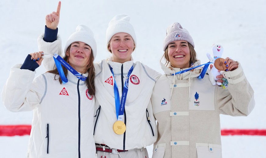 From left, silver medalist United States' Jaelin Kauf, gold medalist United States' Elizabeth Lemley and bronze medalist France's Perrine Laffont celebrate after the women's freest ...