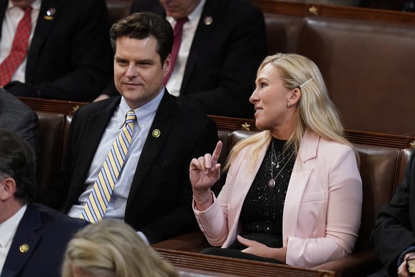Rep. Marjorie Taylor Greene, R-Ga., talks with Rep. Matt Gaetz, R-Fla., in the House chamber as the House meets for the third day to elect a speaker and convene the 118th Congress in Washington, Thurs ...