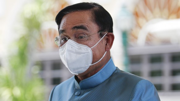 epa10134217 Thai Prime Minister Prayut Chan-o-cha leaves after a weekly cabinet meeting at the Government House in Bangkok, Thailand, 23 August 2022. The prime minister is facing calls to step down by ...