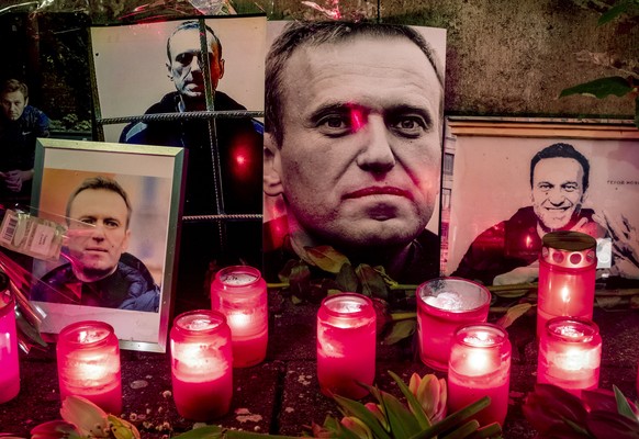 Candles and photos of Russian opposition leader Alexei Navalny are placed near the Russian consulate in Frankfurt, Germany, Saturday, Feb. 17, 2024. Navalny, who crusaded against official corruption a ...