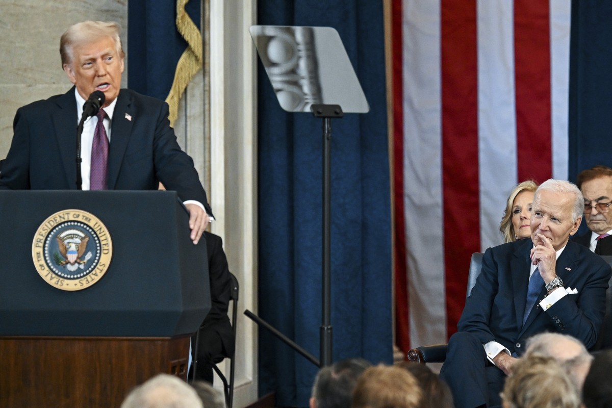 Former President Joe Biden, right, watches as President Donald Trump speaks after taking the oath of office at the 60th Presidential Inauguration in the Rotunda of the U.S. Capitol in Washington, Mond ...