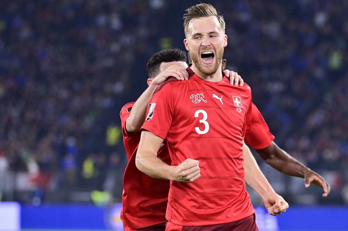 Switzerland's defender Silvan Widmer celebrates after scoring the opening goal during the 2022 FIFA World Cup European Qualifying Group C match between Italy and Switzerland at the Stadio Olimpic ...