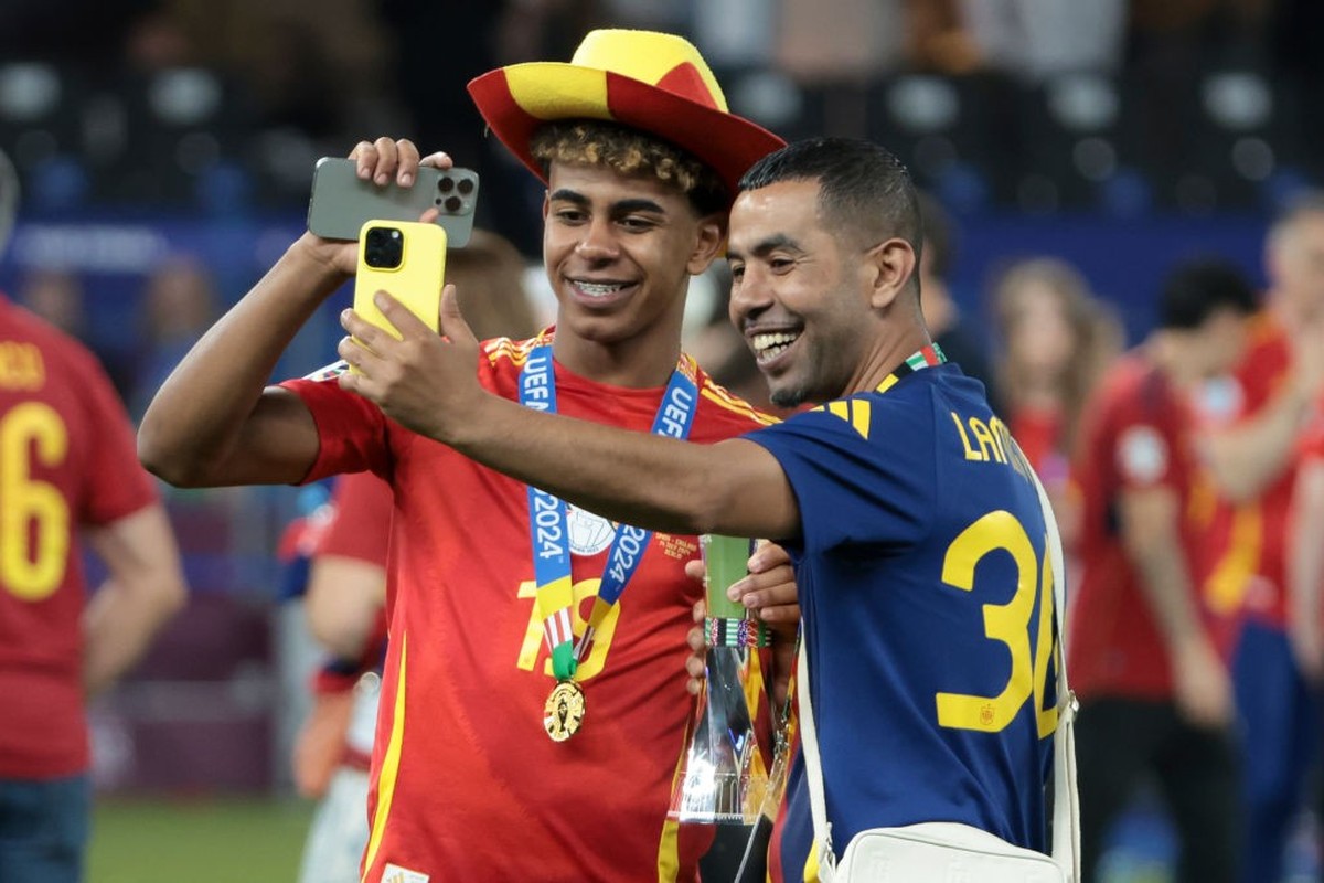 BERLIN, GERMANY - JULY 14: Lamine Yamal of Spain poses with his father Mounir Nasraoui following the UEFA EURO 2024 final match between Spain and England at Olympiastadion on July 14, 2024 in Berlin,  ...