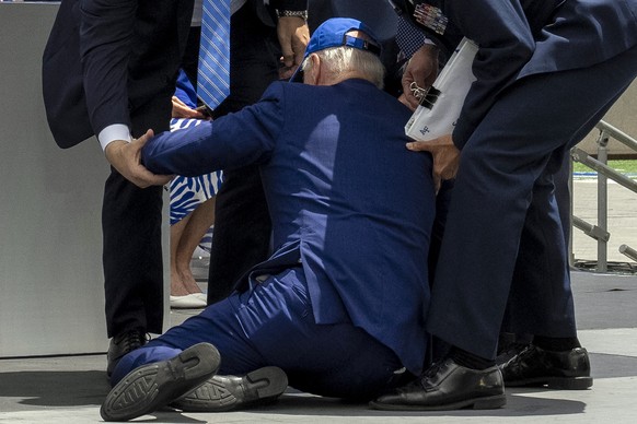 President Joe Biden falls on stage after handing out diplomas during the 2023 United States Air Force Academy Graduation Ceremony at Falcon Stadium, Thursday, June 1, 2023, at the United States Air Fo ...
