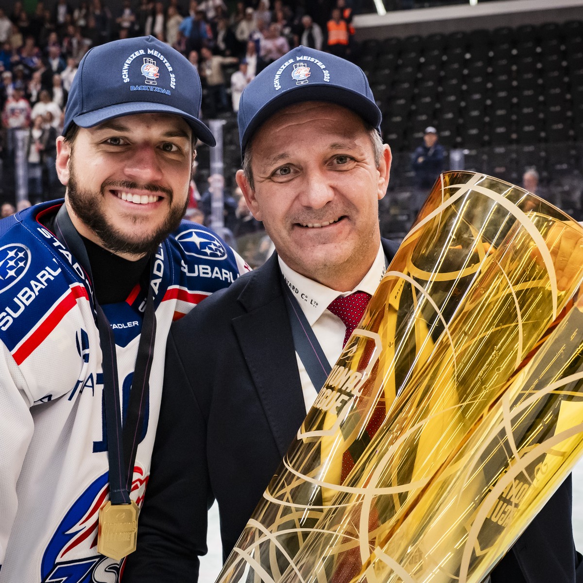 Sven Andrighetto (ZSC) and ZSC Lions' Head coach Marco Bayer celebrate with the trophy of Swiss Champion after winning by 2:3 during the fifth leg of the National League Swiss Championship final  ...