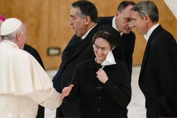 FILE? In this Thursday, Dec. 23, 2021 file photo, Pope Francis shakes hands with Sister Raffaella Petrini, secretary general of the Vatican&#039;s governorship, as he arrives for an audience with empl ...