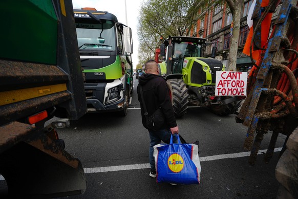 A man walks in between vehicles parked on O'Connell Street on the second day of a national fuel protest against rising fuel prices, in Dublin, Ireland, Wednesday April 8, 2026. (Brian Lawless/PA  ...
