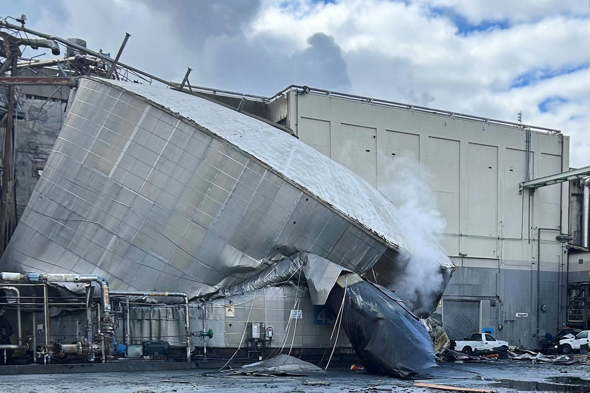 This photo provided by the City of Longview, Wash., shows structural damage to the Nippon Dynawave Packaging Co., after a tank containing hazardous liquid imploded, on Tuesday, May 26, 2026 in Longvie ...