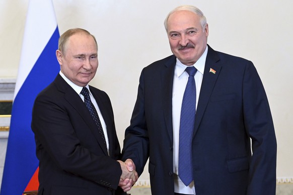 Russian President Vladimir Putin, left, and Belarusian President Alexander Lukashenko shake hands during their meeting in St. Petersburg, Russia, Saturday, June 25, 2022. (Maxim Blinov, Sputnik, Kreml ...