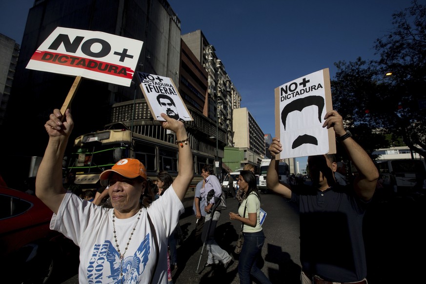 Opposition members take part in a protest against Venezuela&#039;s President Nicolas Maduro, in Caracas, Venezuela, Friday, March 31, 2017. Venezuelans have been thrust into a new round of political t ...