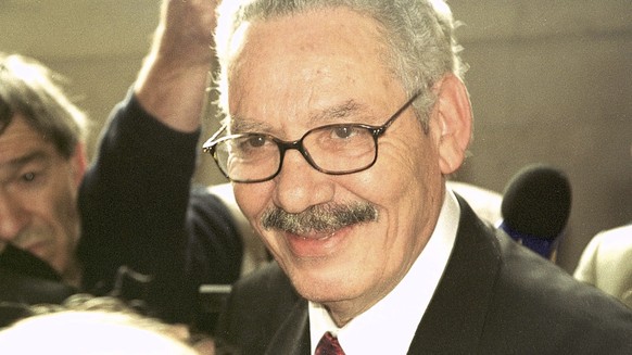 FILE - Former Algerian Defense Minister and retired Gen. Khaled Nezzar smiles as he answers reporters at the Paris courthouse Monday, July 1, 2002. Swiss federal prosecutors said Tuesday they have ind ...