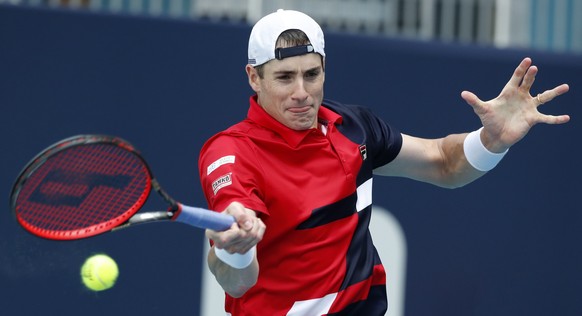 epa07471996 John Isner of the US in action against Felix Auger Aliassime of Canada during their men&#039;s semifinals match at the Miami Open tennis tournament in Miami, Florida, USA, 29 March 2019. E ...