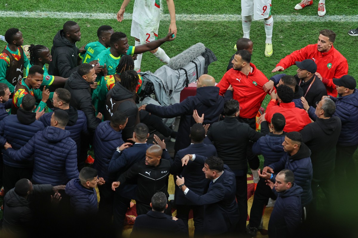 Players from both sides clash after a controversial penalty was awarded to Morocco late on during the Africa Cup of Nations final soccer match between Senegal and Morocco in Rabat, Morocco, Sunday, Ja ...