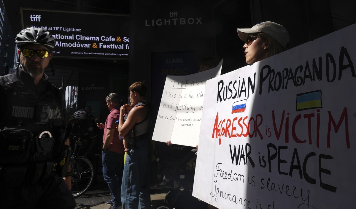 Protesters gather outside the TIFF Lightbox before a screening of the documentary film "Russians At War" in Toronto, Tuesday, Sept. 17, 2024. (Chris Young/The Canadian Press via AP)