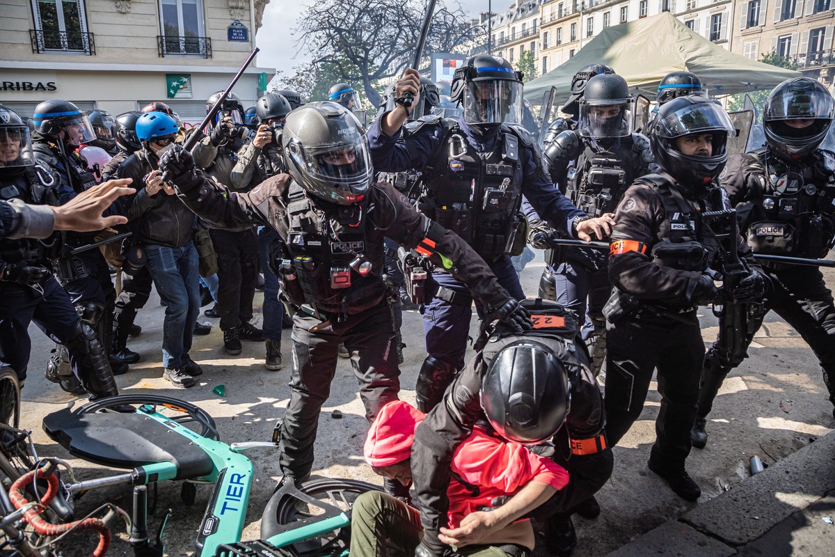 epa10602384 Police officers from the BRAV-M (Brigade of Repression of Motorized Violent Action) detain a demonstrator during the annual May Day march in Paris, France, 01 May 2023. Despite the Constit ...