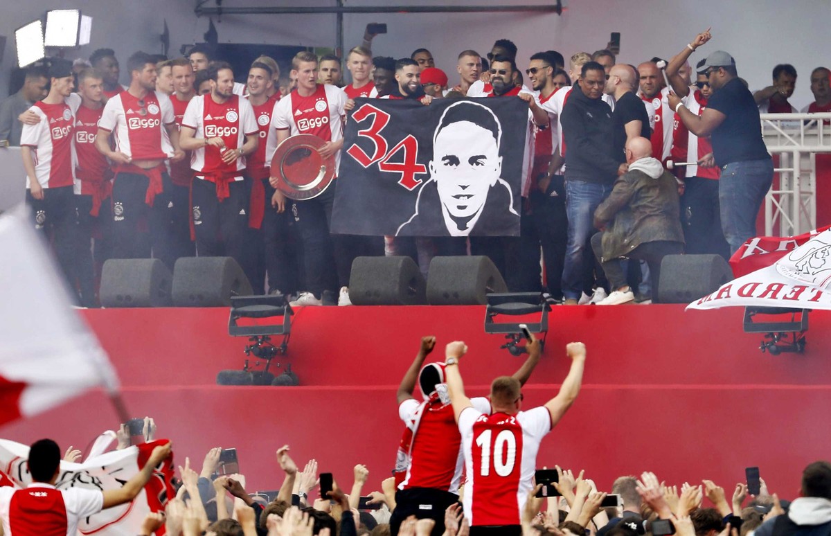 epa07576005 Abdelhak Nouri's father and brother (C) appear on the podium during the celebration at the Museumplein for the win of the Dutch Eredivisie soccer championship by Ajax Amsterdam in Ams ...