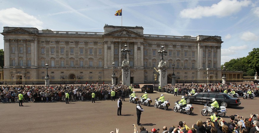 FILE - In this file photo dated Tuesday, May 24, 2011, The Royal Standard flag flies from above Buckingham Palace in London as the convoy carrying U.S. President Barack Obama arrives. The invitation t ...