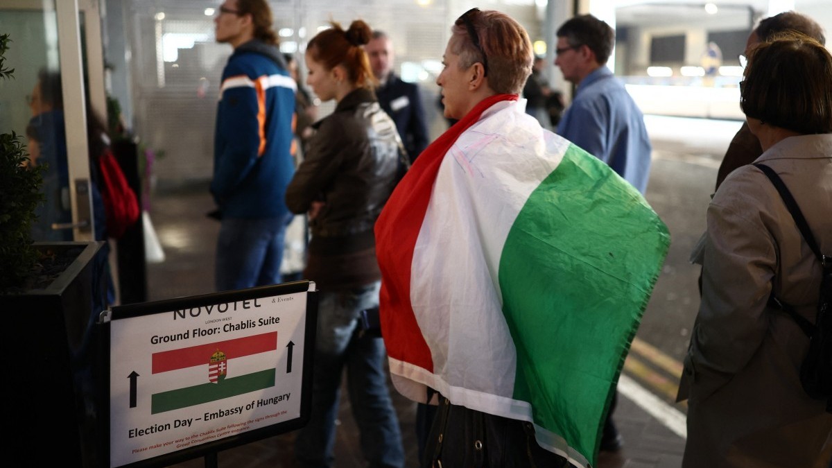Voters queue to enter the polling station set up at a hotel in west London, as they vote in the Hungarian election on April 12, 2026. The vote could end Hungarian Prime Minister Viktor Orban's 16 ...
