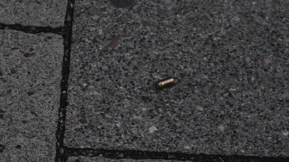 A screen grab taken from video footage shows a bullet casing lying in the street near to the Olympia shopping mall during a shooting rampage in Munich, Germany July 22, 2016. dedinac/Marc Mueller/Hand ...