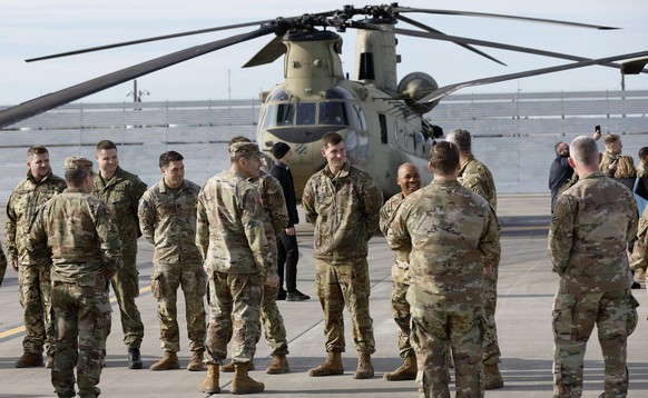 epa12547639 U.S. Army Europe and Africa Commanding General Gen. Christopher Donahue (center-left, with back) meets US helicopter pilots and instructors during his visit to the US Army garrison Black S ...
