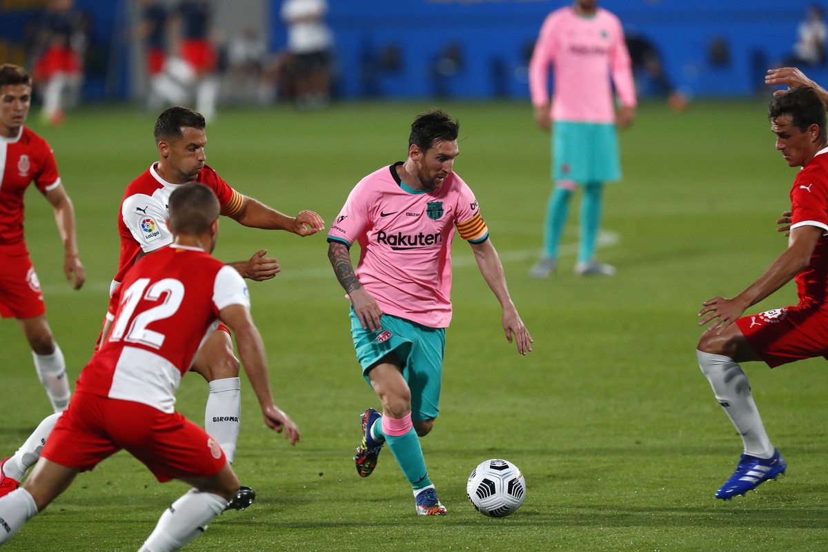 Barcelona's Lionel Messi, centre, in action during the pre-season friendly soccer match between Barcelona and Girona at the Johan Cruyff Stadium in Barcelona, Spain, Wednesday, Sept. 16, 2020. (A ...