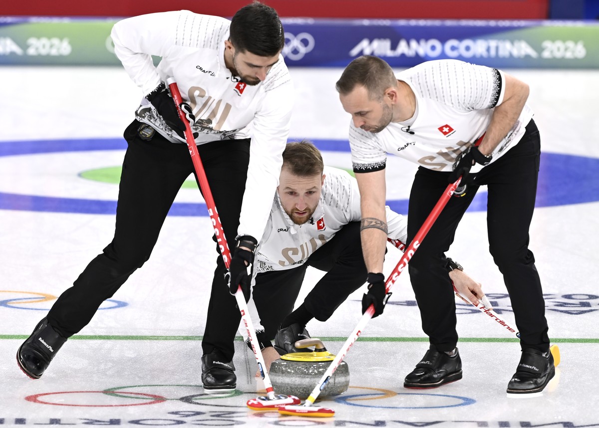 epa12751532 Switzerland's Yannick Schwaller (C) delivers the stone as teammates Pablo Lachat-Couchepin (L) and Sven Michel prepare to sweep in the Men's Curling match between Switzerland and ...