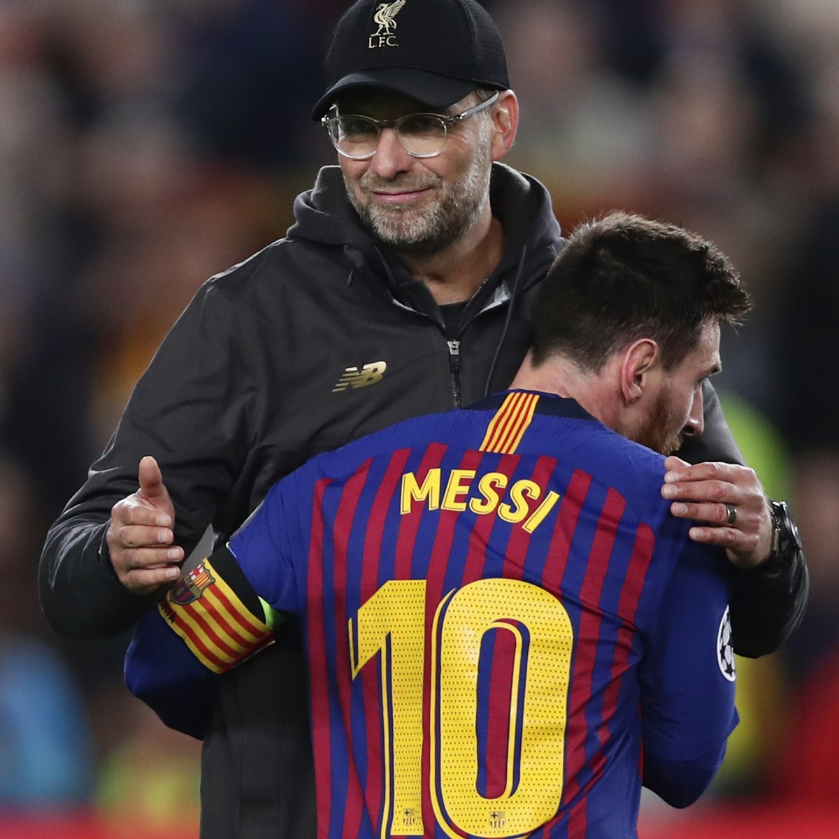Barcelona's Lionel Messi, who scored two of the team's three goals, hugs Liverpool coach Juergen Klopp after the Champions League semifinal first leg soccer match between FC Barcelona and Li ...