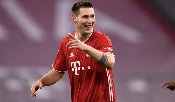 epa08917415 Bayern&#039;s Niklas Suele (L) celebrates scoring the third goal during the German Bundesliga soccer match between FC Bayern Muenchen and 1. FSV Mainz 05 at Allianz Arena in Munich, German ...