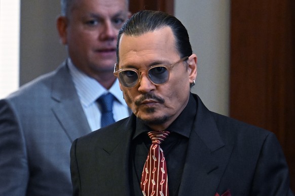 Actor Johnny Depp arrives in the courtroom at the Fairfax County Circuit Court in Fairfax, Va., Tuesday May 3, 2022. Depp sued his ex-wife Amber Heard for libel in Fairfax County Circuit Court after s ...