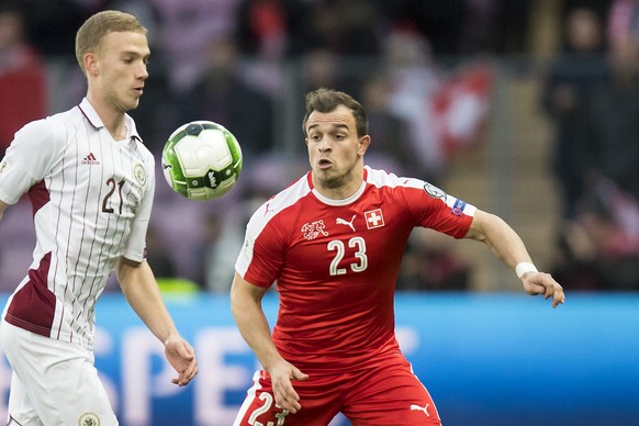 Latvia&#039;s Midfielder G勅ebs K勅uskins, left, fights for the ball with Swiss forward Xherdan Shaqiri, right, during the 2018 Fifa World Cup Russia group B qualification soccer match between Switzerla ...