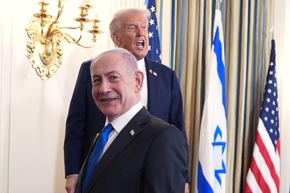 President Donald Trump speaks upon departing a news conference with Israeli Prime Minister Benjamin Netanyahu, in foreground, in the State Dining Room of the White House, Monday, Sept. 29, 2025, in Wa ...