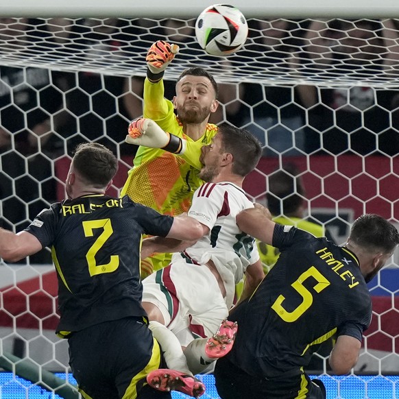 Scotland&#039;s goalkeeper Angus Gunn, up, and Hungary&#039;s Barnabas Varga, center, collide during a Group A match between Scotland and Hungary at the Euro 2024 soccer tournament in Stuttgart, Germa ...