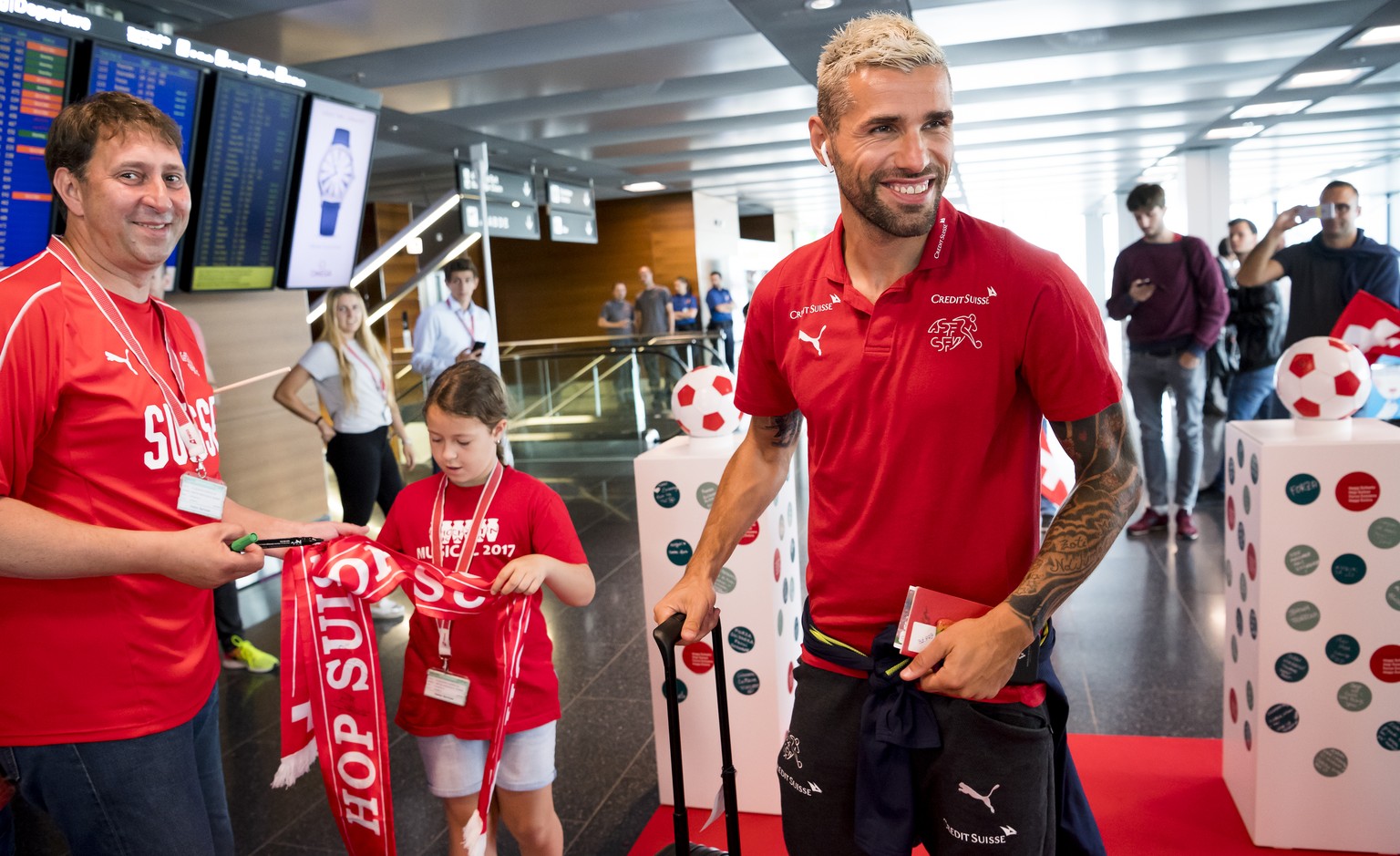 Switzerland&#039;s national soccer team player Valon Behrami walks inside the aiport before taking off for Samara, at the Zurich airport, in Kloten, Switzerland, Monday, June 11, 2018. The Swiss natio ...