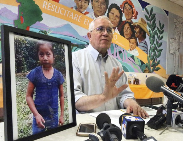 Annunciation House director Ruben Garcia answers questions from the media after reading a statement from the family of Jakelin Caal Maquin, pictured at left, during a press briefing at Casa Vides, Sat ...