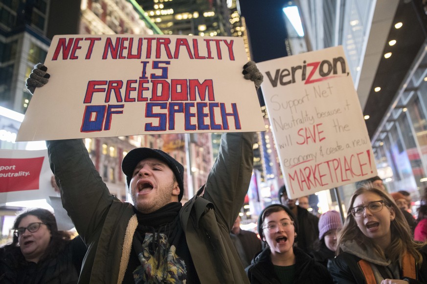 FILE - In this Thursday, Dec. 7, 2017, file photo, demonstrators rally in support of net neutrality outside a Verizon store in New York. The Federal Communications Commission is voting Thursday, Dec.  ...