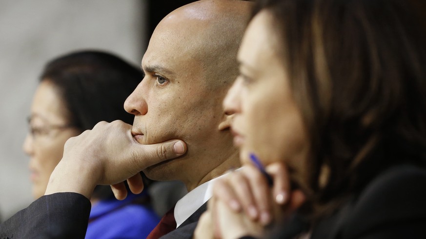 epa07287558 Democratic Senator from New Jersey Cory Booker (C) and Democratic Senator from California Kamala Harris (R) attend the the Senate Judiciary Committee confirmation hearing for Attorney Gene ...