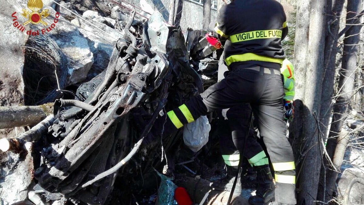 epa06641160 A handout photo made available by the fire department shows firefighters try to retrieve a car aftera landslide came down on the 337 road at Val Vigezzo in between to l'Ossola (Vco) a ...