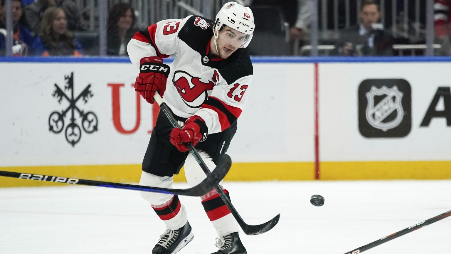 New Jersey Devils center Nico Hischier passes the puck during the third period of the team&#039;s NHL hockey game against the New York Islanders, Thursday, Oct. 20, 2022, in Elmont, N.Y. The Devils wo ...