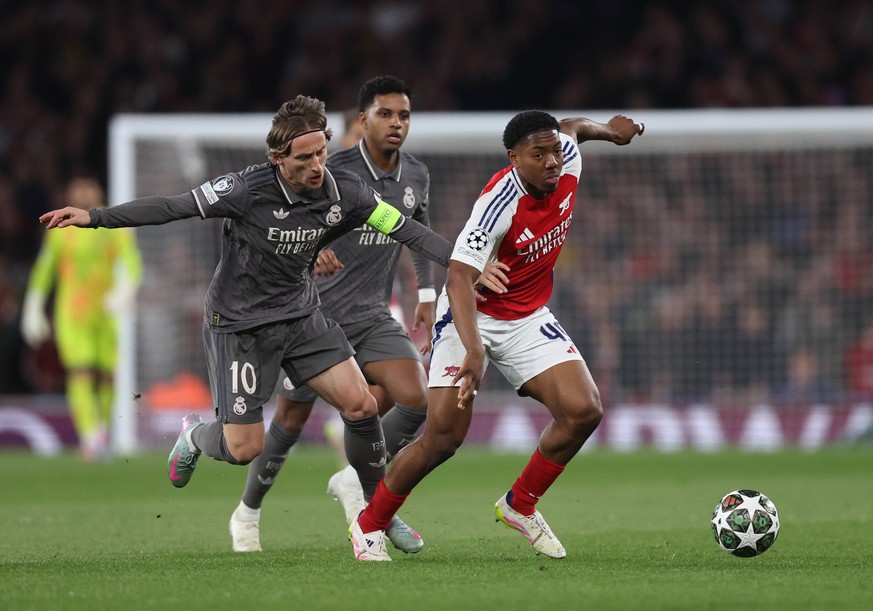 London, England, 8th April 2025. Myles Lewis-Skelly of Arsenal escapes Luka Modric of Real Madrid during the Arsenal vs Real Madrid UEFA Champions League match at the Emirates Stadium, London. Picture ...