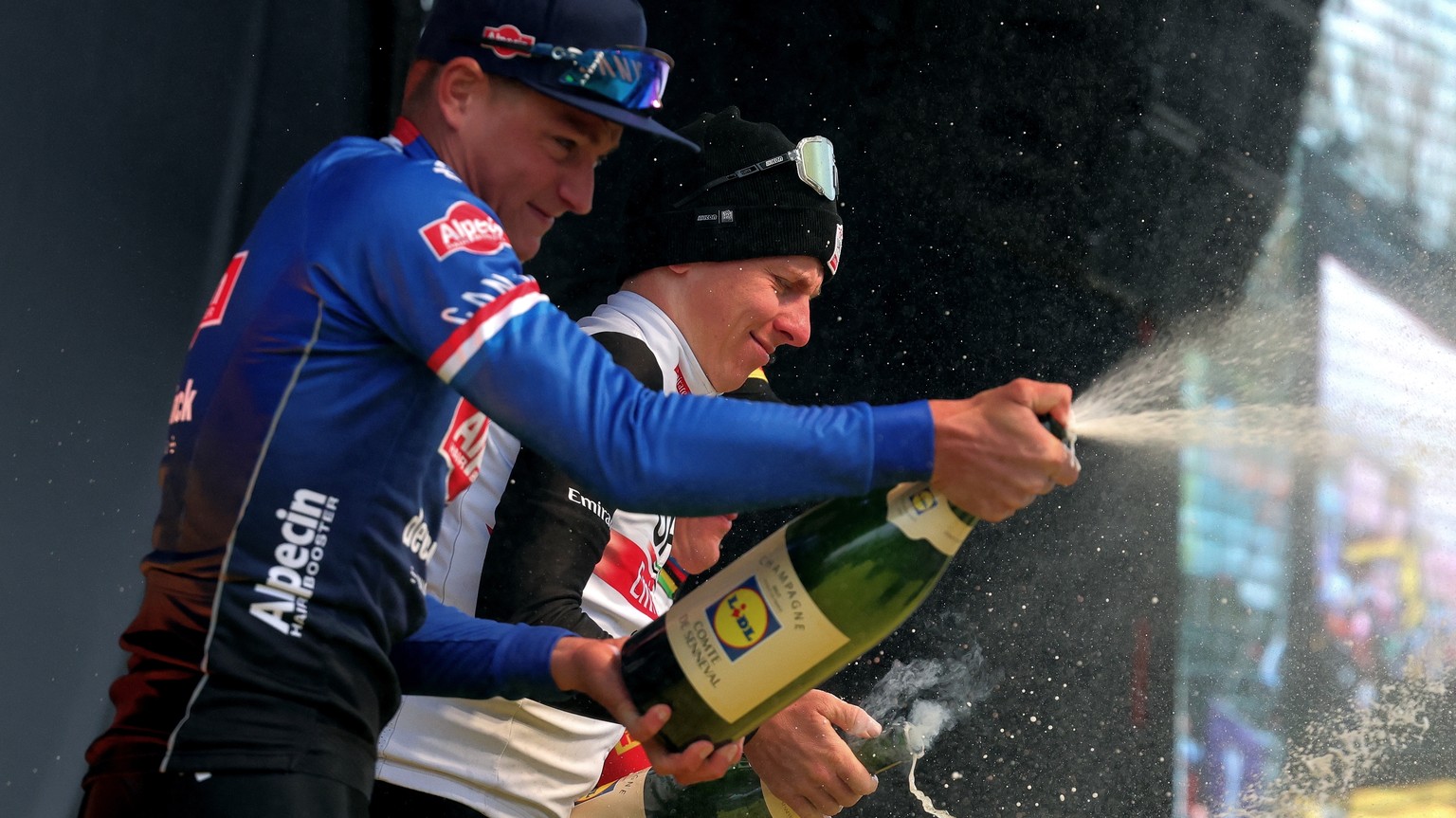 epa10555748 Winner Slovenia&#039;s Tadej Pogacar (2-nd L), of UAE Team Emirates and 2-nd placed Netherlands&#039; Mathieu Van Der Poel, of Alpecin-Deceunink team (L) celebrate during the podium ceremo ...