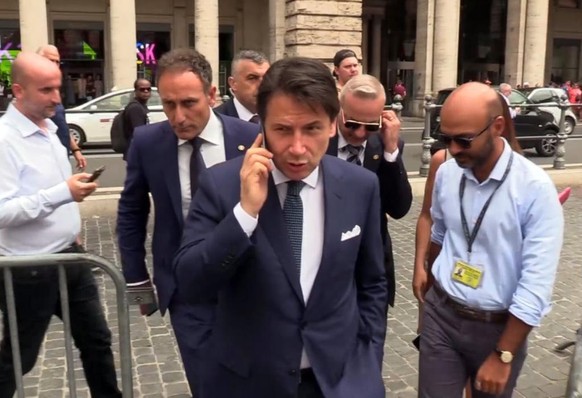 epa07762065 A video grab shows Italian Prime Minister Giuseppe Conte (C) after the meeting with Italian President Sergio Mattarella (not pictured), in Rome, Italy, 08 August 2019. Premier Giuseppe Con ...