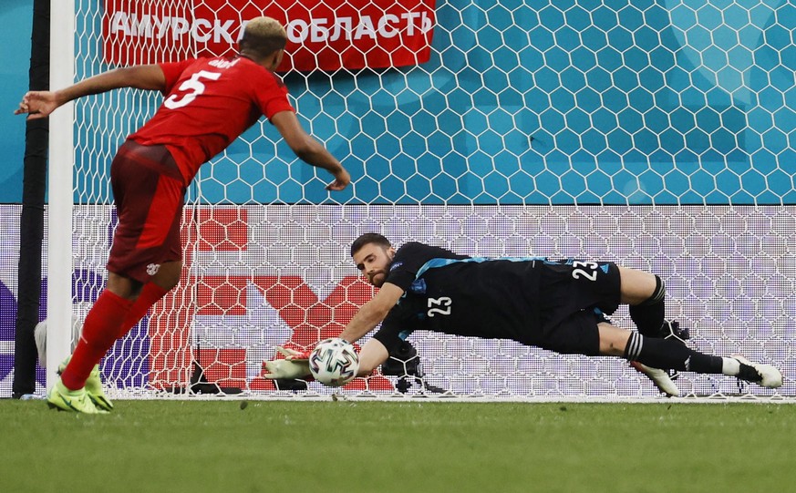 epa09318735 Goalkeeper Unai Simon (R) of Spain saves the kick from Manuel Akanji of Switzerland during the penalty shoot-out in the UEFA EURO 2020 quarter final match between Switzerland and Spain in  ...