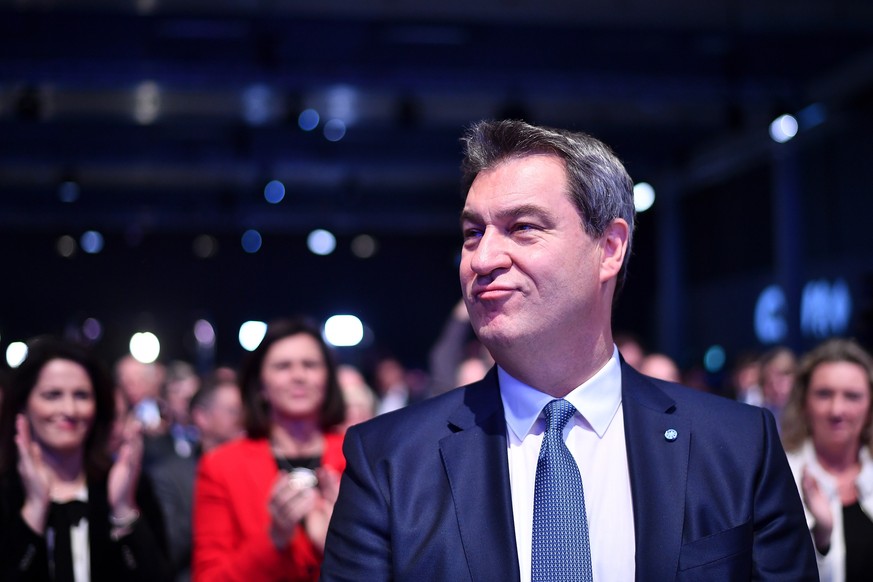 epa07299456 Bavarian Prime Minister Markus Soeder smiles while being applauded by delegates after being elected the new party chairman at a convention of the Christian Sosial Union (CSU) party, in Mun ...