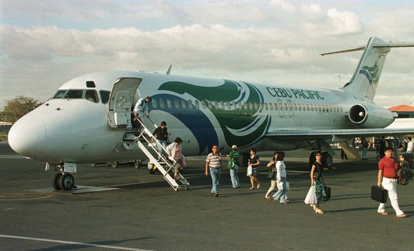 Passengers disembark from a Cebu Pacific DC-9 passenger plane shortly upon landing at the Manila Domestic airport on Monday February 2, 1998. A simillar McDonnell Douglas DC-9 plane with 105 passenger ...