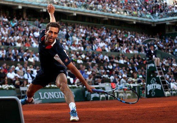 epa06010561 Albert Ramos-Vinolas of Spain in action against Novak Djokovic of Serbia during their men’s singles 4th round match during the French Open tennis tournament at Roland Garros in Paris, Fran ...