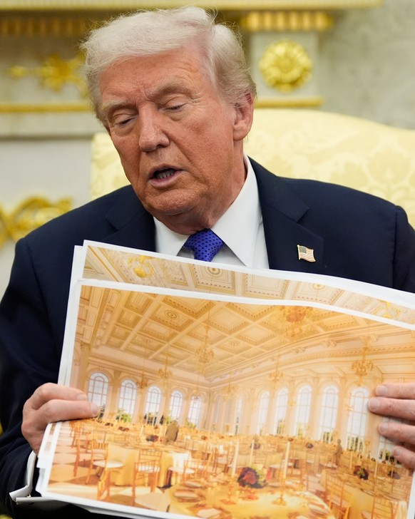 President Donald Trump holds an artist rendering of the interior of the new White House ballroom as meets with NATO Secretary General Mark Rutte in the Oval Office of the White House, Wednesday, Oct.  ...